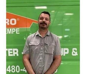 man in front of green SERVPRO truck 